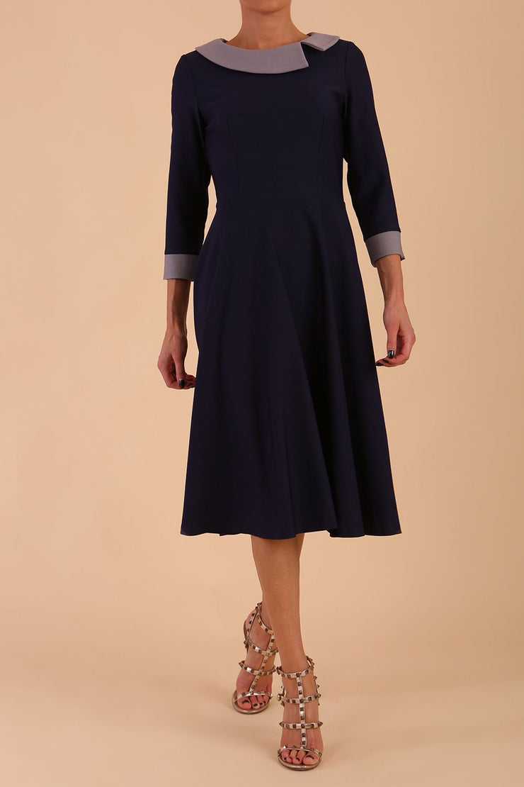 Model wearing Diva catwalk Coralia swing dress in navy / sky grey contrast with three quarter sleeve figure fitted front image