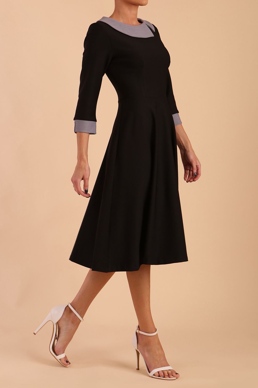 Model wearing Diva catwalk Coralia swing dress in black/ slate grey with three quarter sleeve figure fitted side image