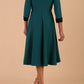 Model wearing Diva catwalk Coralia swing dress in pacific green / Black contrast with three quarter sleeve figure fitted back image