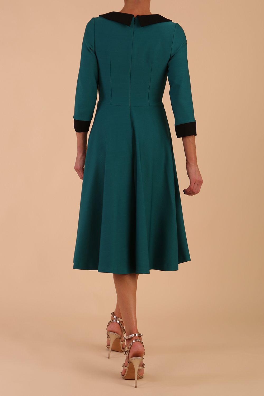 Model wearing Diva catwalk Coralia swing dress in pacific green / Black contrast with three quarter sleeve figure fitted back image