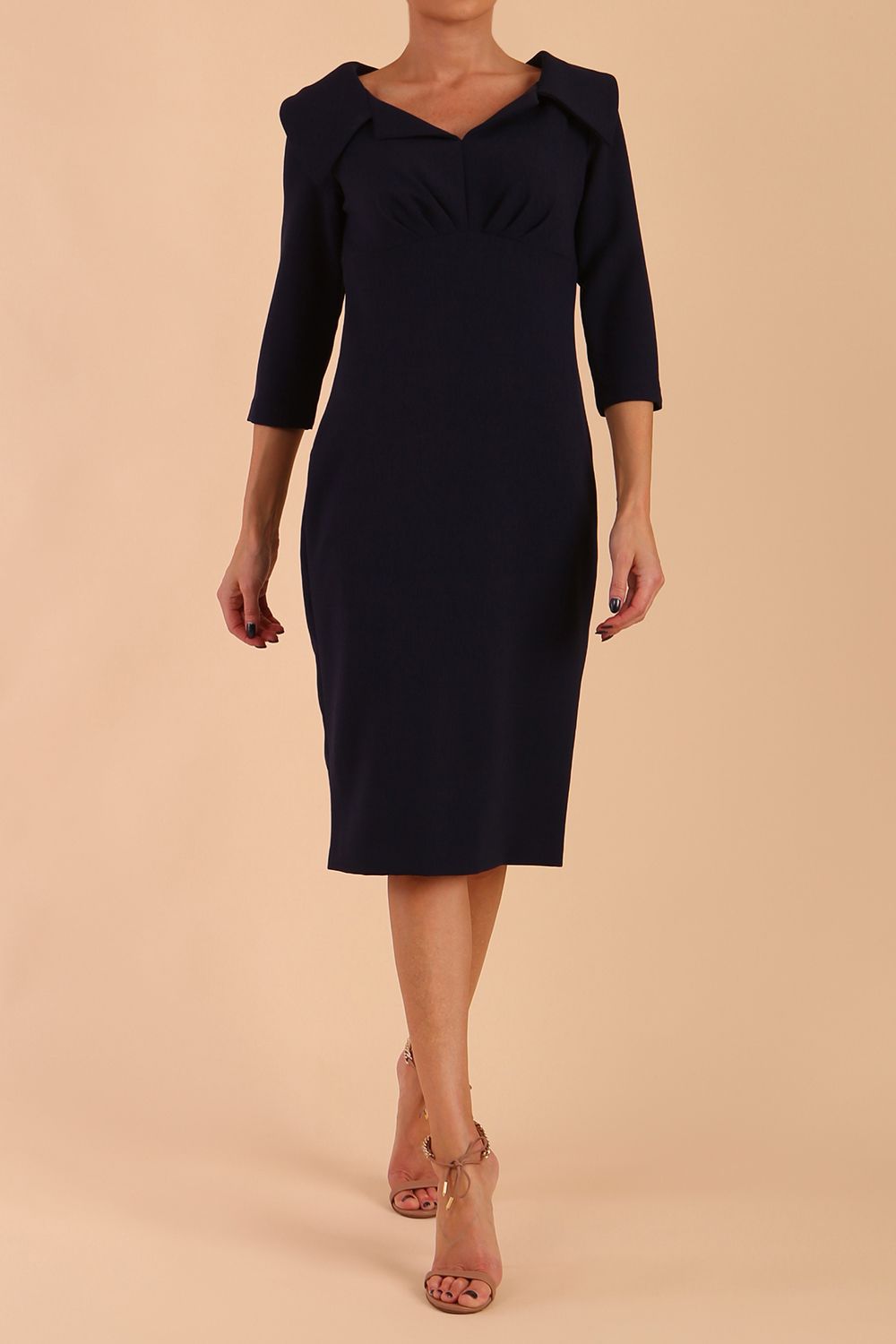Model wearing Diva catwalk Venetia pencil figure fitted dress in navy blue with three quarter sleeve front