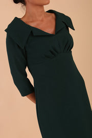 Model wearing Diva catwalk Venetia figure fitted pencil dress in forest green with three quarter sleeve front