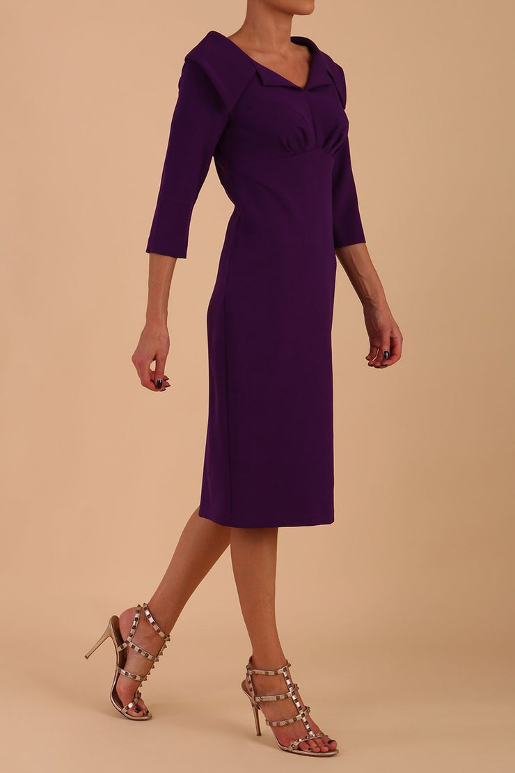 Model wearing Diva catwalk Venetia pencil figure fitted dress in deep purple with three quarter sleeve front
