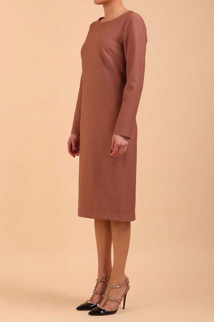 brunette model wearing diva catwalk cora white pencil dress with long sleeves and rounded neckline with pockets in colour acorn brown on side front