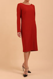 brunette model wearing diva catwalk cora white pencil dress with long sleeves and rounded neckline with pockets in colour garnet red on front