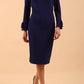 brunette model wearing diva catwalk fitted dress with sleeves called Alma Pencil-skirt dress in colour oxford blue with bow detail on sleeves front