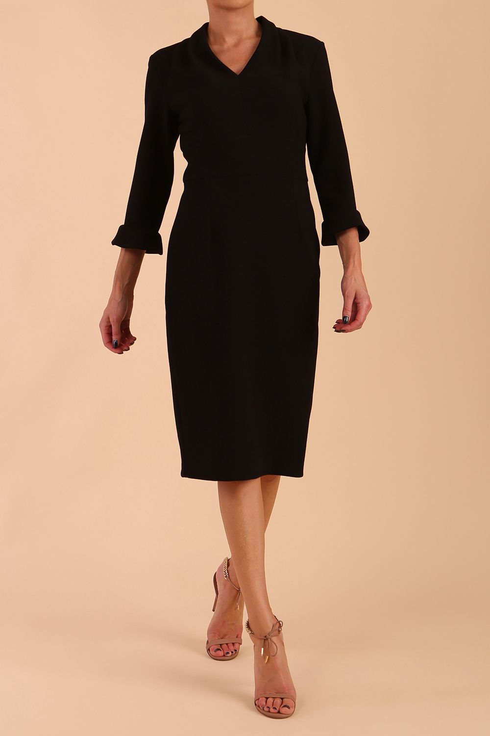 brunette model wearing diva catwalk adriana pencil dress with low v-neck and pleating around shoulders with three quarter sleeve detailed on end and wide waistband in dark navy front