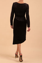 Brunette Model wearing assymetric glitter and black velvet long sleeve dress back image
