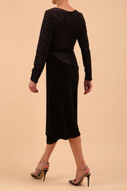 Brunette Model wearing assymetric glitter and black velvet long sleeve dress side back image