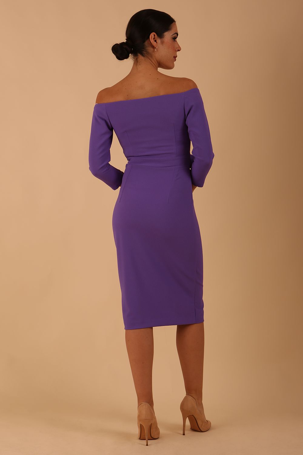 model is wearing diva catwalk charisma dress odd shoulder design with pleated detail down the front and flower detail on a side in opulent violet colour