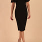 brunette model is wearing diva catwalk hermione pencil dress with tie shoulder details and empire waistline in black front