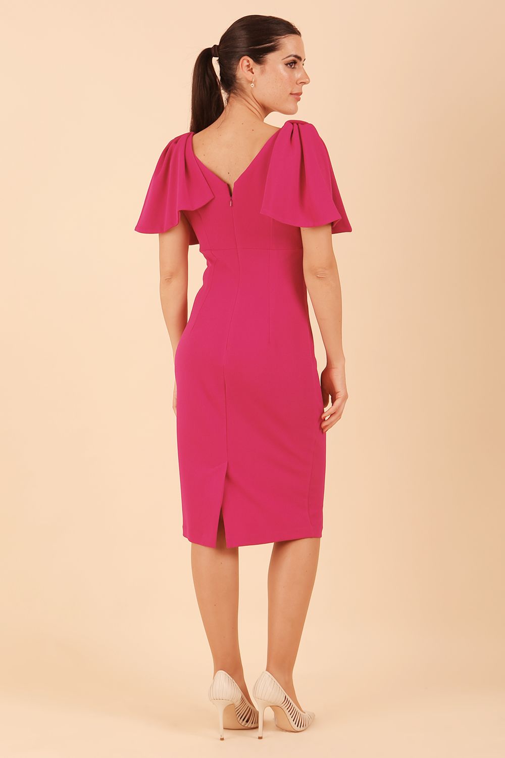 brunette model is wearing diva catwalk hermione pencil dress with tie shoulder details and empire waistline in magenta haze back