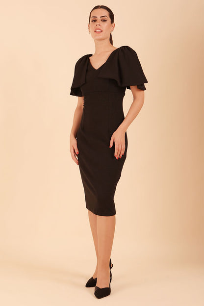 brunette model is wearing diva catwalk hermione pencil dress with tie shoulder details and empire waistline in black front