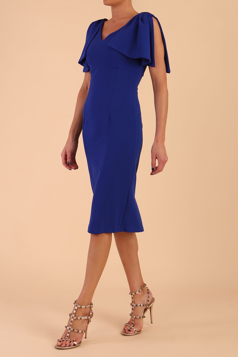 brunette model is wearing diva catwalk hermione pencil dress with tie shoulder details and empire waistline in cobalt blue front side