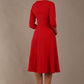 model is wearing diva catwalk casares swing dress with a keyhole neckline three quarter sleeve dress with pocket detail in red front (Scarlet Red)