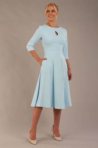 model is wearing diva catwalk casares swing dress with a keyhole neckline three quarter sleeve dress with pocket detail in sky blue front (Sky Blue)
