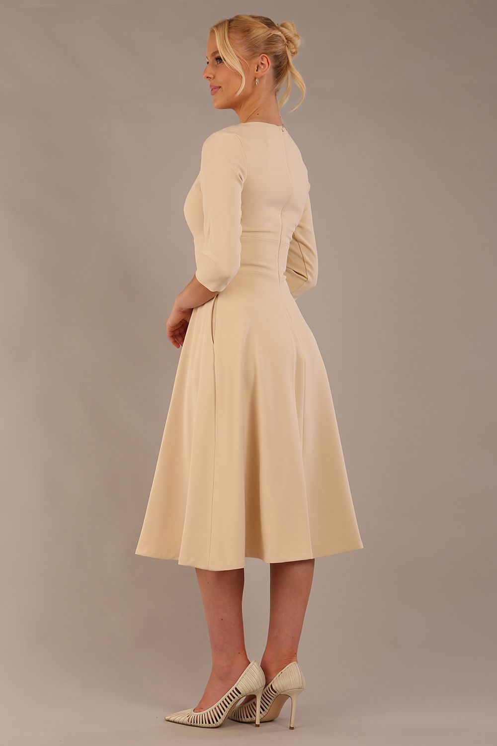 model is wearing diva catwalk casares swing dress with a keyhole neckline three quarter sleeve dress with pocket detail in Sandshell Beige back (Sandshell Beige)