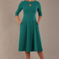 model is wearing diva catwalk casares swing dress with a keyhole neckline three quarter sleeve dress with pocket detail in Parasailing green front (Parasailing Green)