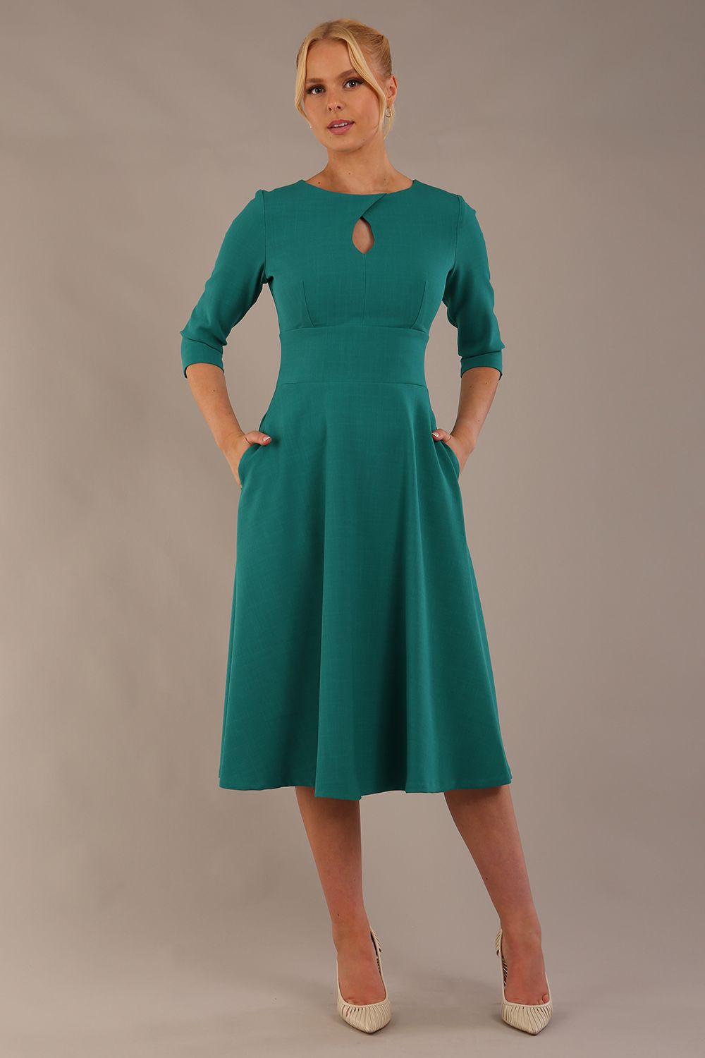 model is wearing diva catwalk casares swing dress with a keyhole neckline three quarter sleeve dress with pocket detail in Parasailing green front (Parasailing Green)