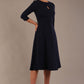  model is wearing diva catwalk casares swing dress with a keyhole neckline three quarter sleeve dress with pocket detail in navy blue front (Navy Blue)