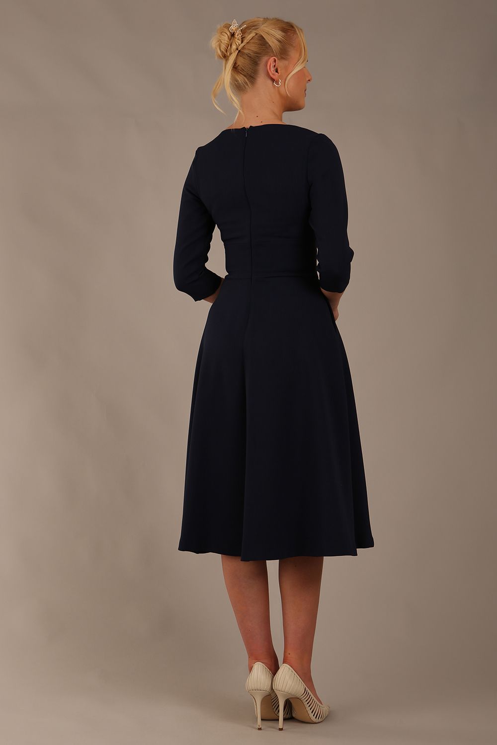  model is wearing diva catwalk casares swing dress with a keyhole neckline three quarter sleeve dress with pocket detail in navy blue back (Navy Blue)