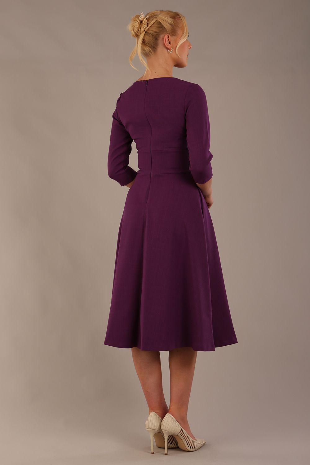 model is wearing diva catwalk casares swing dress with a keyhole neckline three quarter sleeve dress with pocket detail in imperial purple back (Imperial Purple)