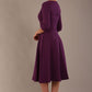 model is wearing diva catwalk casares swing dress with a keyhole neckline three quarter sleeve dress with pocket detail in imperial purple side back (Imperial Purple)