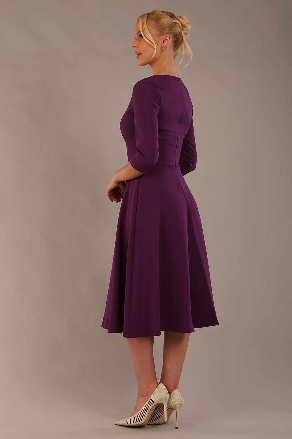 model is wearing diva catwalk casares swing dress with a keyhole neckline three quarter sleeve dress with pocket detail in imperial purple side back (Imperial Purple)