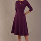 model is wearing diva catwalk casares swing dress with a keyhole neckline three quarter sleeve dress with pocket detail in imperial purple side front (Imperial Purple)