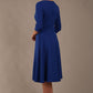 model is wearing diva catwalk casares swing dress with a keyhole neckline three quarter sleeve dress with pocket detail in cobalt blue back (Cobalt Blue)