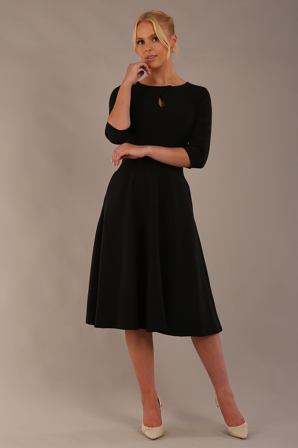 model is wearing diva catwalk casares swing dress with a keyhole neckline three quarter sleeve dress with pocket detail in black front (Black)