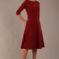 model is wearing diva catwalk casares swing dress with a keyhole neckline three quarter sleeve dress with pocket detail in Wine front side (Wine)