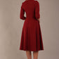 model is wearing diva catwalk casares swing dress with a keyhole neckline three quarter sleeve dress with pocket detail in Wine back (Wine)