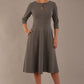 model is wearing diva catwalk casares swing dress with a keyhole neckline three quarter sleeve dress with pocket detail in Castlerock Grey  front (Castlerock Grey)