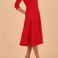 Brunette model is wearing diva catwalk casares swing dress with a keyhole neckline three quarter sleeve dress with pocket detail in Scarlet Red side front