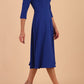 Brunette model is wearing diva catwalk casares swing dress with a keyhole neckline three quarter sleeve dress with pocket detail in Cobalt Blue side front