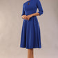 Brunette model is wearing diva catwalk casares swing dress with a keyhole neckline three quarter sleeve dress with pocket detail in cobalt blue front