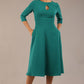 Brunette model is wearing diva catwalk casares swing dress with a keyhole neckline three quarter sleeve dress with pocket detail in Parasailing green front