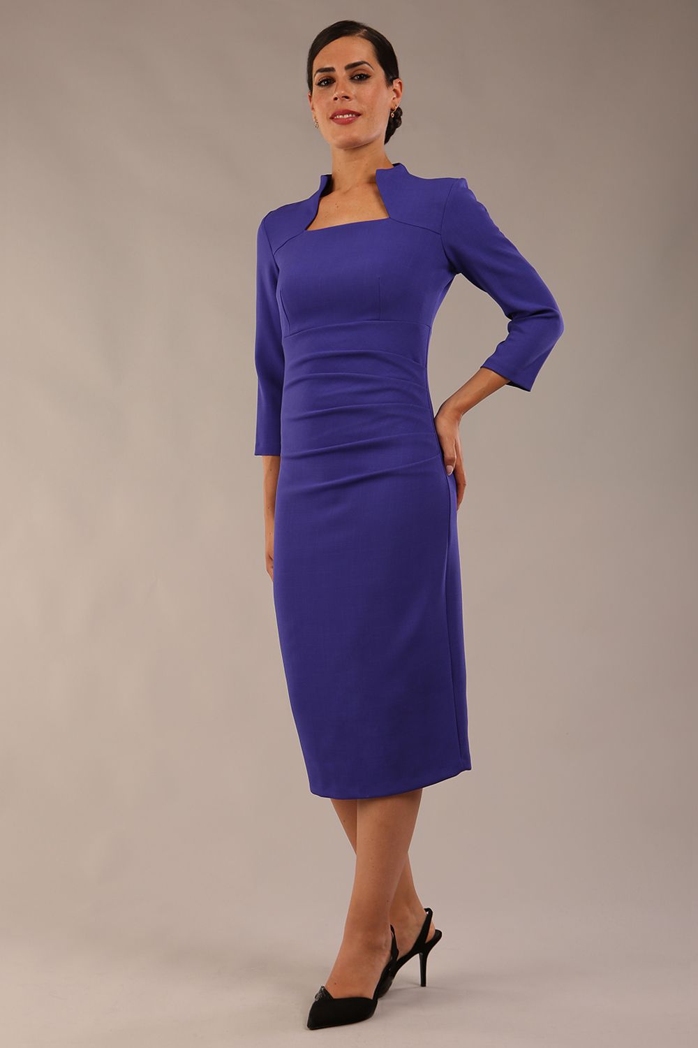 model is wearing diva catwalk plaza sheath dress with high neck Trapezium neckline cutout and three quarter sleeve pretty dress in Indigo blue front