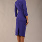 model is wearing diva catwalk plaza sheath dress with high neck Trapezium neckline cutout and three quarter sleeve pretty dress in Indigo blue back