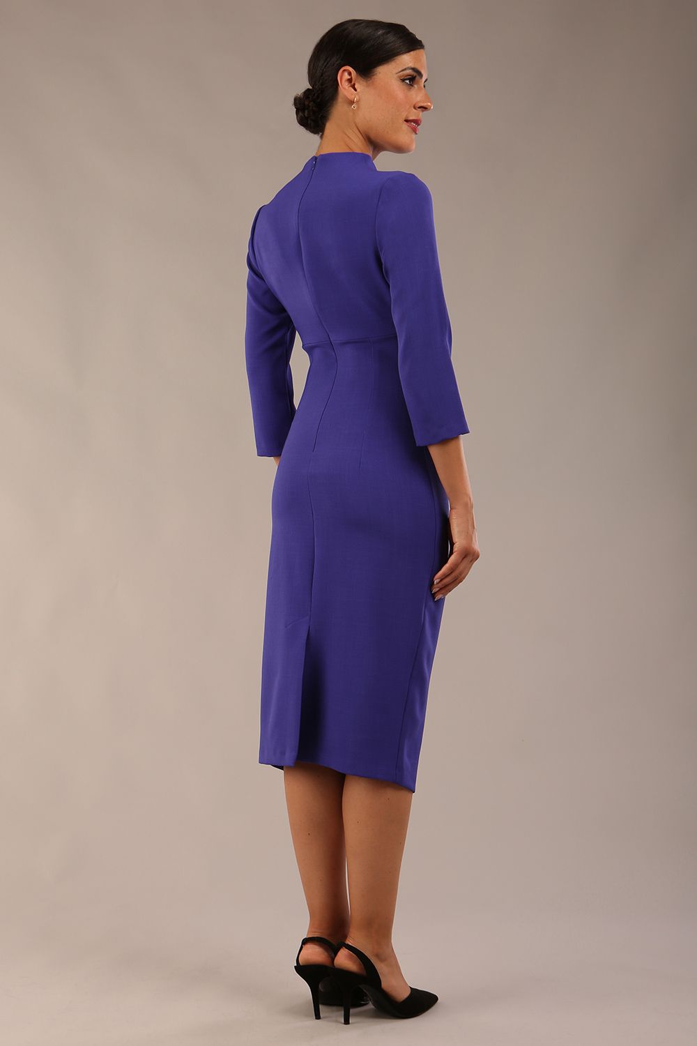 model is wearing diva catwalk plaza sheath dress with high neck Trapezium neckline cutout and three quarter sleeve pretty dress in Indigo blue back