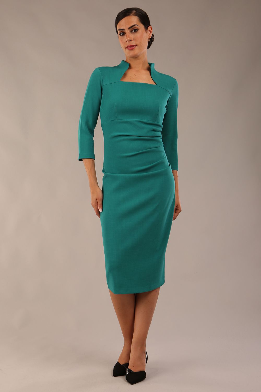 model is wearing diva catwalk plaza sheath dress with high neck Trapezium neckline cutout and three quarter sleeve pretty dress in parasailing green colour