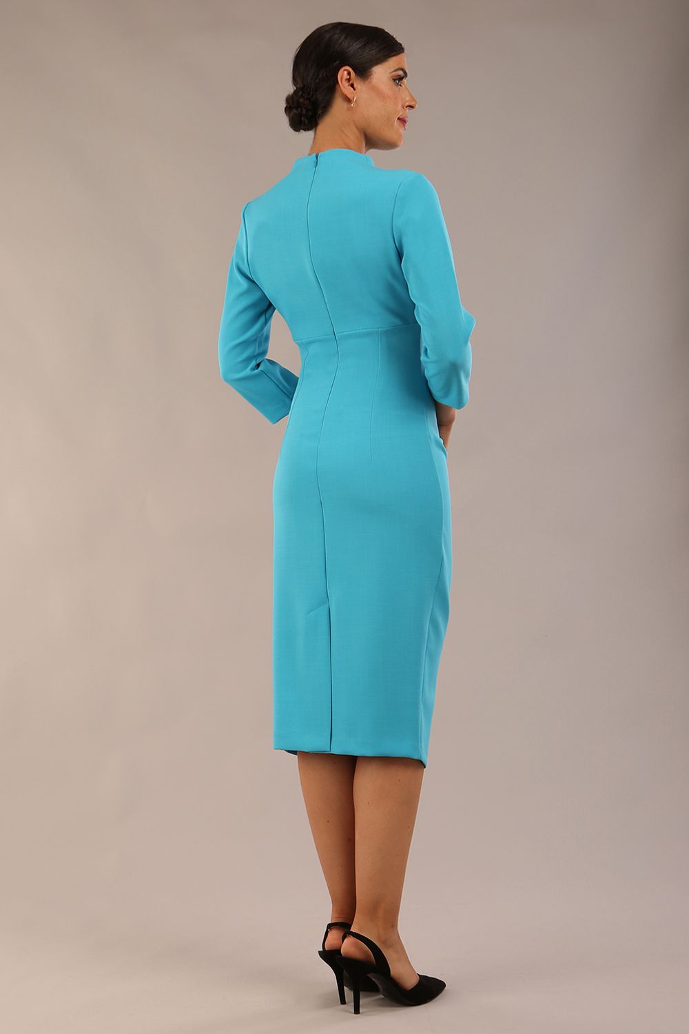 model is wearing diva catwalk plaza sheath dress with high neck Trapezium neckline cutout and three quarter sleeve pretty dress in azure blue colour