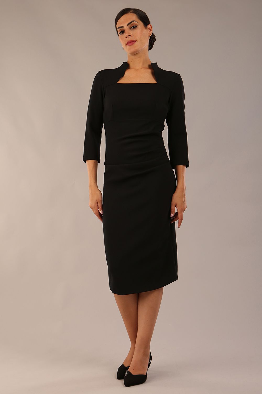 model is wearing diva catwalk plaza sheath dress with high neck Trapezium neckline cutout and three quarter sleeve pretty dress in black front