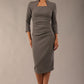 model is wearing diva catwalk plaza sheath dress with high neck Trapezium neckline cutout and three quarter sleeve pretty dress in castlerock grey colour