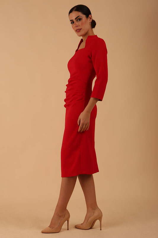 model is wearing diva catwalk plaza sheath dress with high neck Trapezium neckline cutout and three quarter sleeve pretty dress in Scarlet Red colour