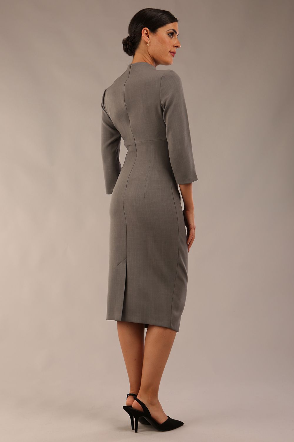 model is wearing diva catwalk plaza sheath dress with high neck Trapezium neckline cutout and three quarter sleeve pretty dress in castlerock grey colour