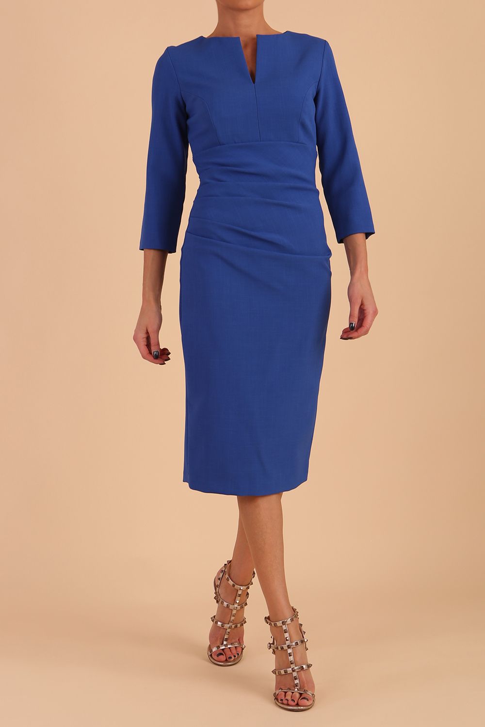 model is wearing diva catwalk chandos sheath dress with three quarter sleeve and slit in the middle of the neckline in cobalt blue front