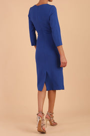 model is wearing diva catwalk chandos sheath dress with three quarter sleeve and slit in the middle of the neckline in cobalt blue back