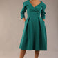 model is wearing diva catwalk gatsby swing dress with pocket detail and wide v-neck collar and buttons down the front panel in parasailing green front